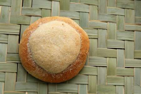 Freshly made Ojo de Pancha or Ox bread from Mexican cuisine in a basket, or napkin accompanied by coffeeの写真素材