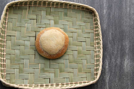 Freshly made Ojo de Pancha or Ox bread from Mexican cuisine in a basket, or napkin accompanied by coffeeの写真素材