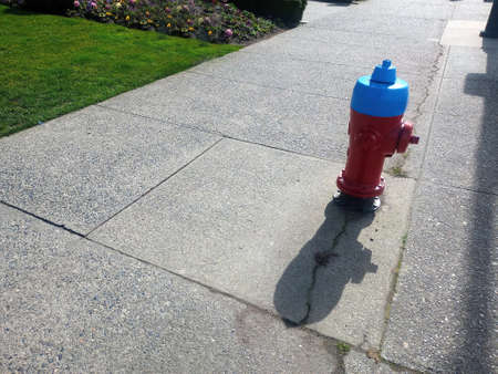 A red fire hydrant, faucet or fire hydrant, a water intake to provide a flow rate in the event of a fire. Water can be obtained from the urban supply network or from a reservoir, bの写真素材