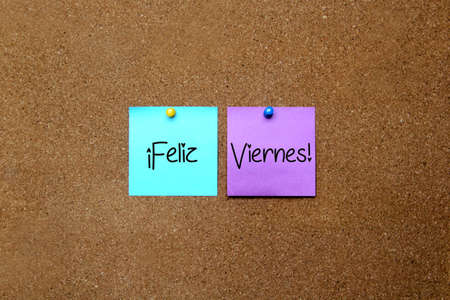 white and colored notes on cork board with message "Happy Friday"の写真素材