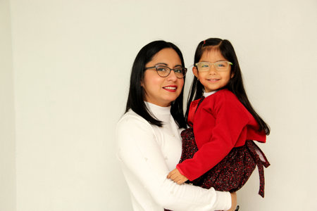 Latin mom and daughter show their family love very happy, elegant and casual, ready to celebrate the...