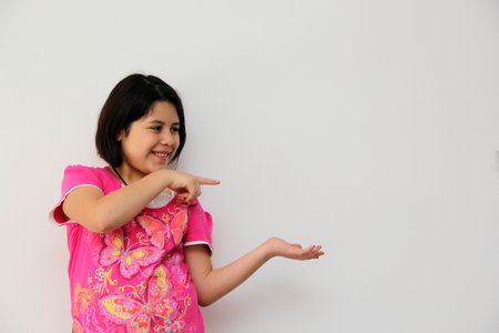 Happy and excited Hispanic 10-year-old girl is amazed at a promotion or discount of something that children like very muchの写真素材