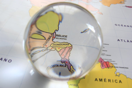 Crystal ball on a world map that highlights a country to highlight it as a magnifying glass and note its economic and financial importance in the world: Belizeの写真素材