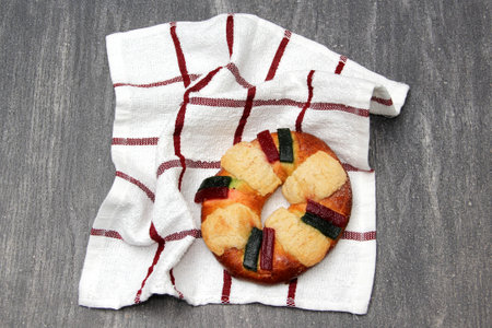 The roscn or rosa de reyes or king cake, a Christmas sweet pastry bun decorated with colored...