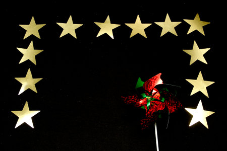 Sparkling stars as decorated frame for Christmas messages with poinsettia flowers and pinwheels