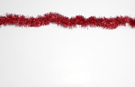 Bright red garland to frame Christmas message along with Mexican poinsettia flowers, handmade doll, canes and stars to celebrate Christmasの写真素材