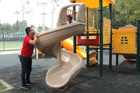 Latino and brunette single dad and daughter play in the park, get on rides and spend quality time...