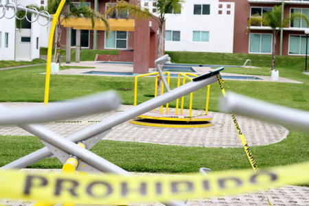 Children's games cordoned off with yellow tape "Forbidden" due to covid-19 health contingency, new normalの写真素材
