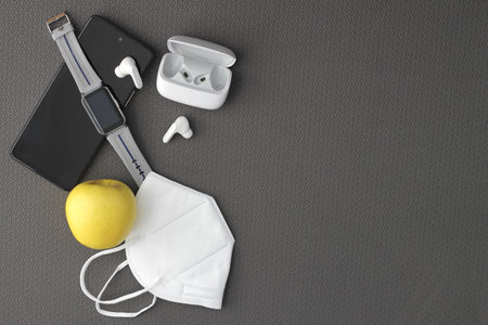 Fit objects to exercise in the gym prepared and protected such as a cell phone, watch, headphones and face masks to avoid contagionの写真素材