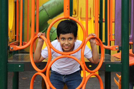 9-year-old Latino brown child boy plays in the park games lives in poverty in Latin America