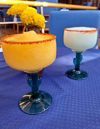 Cups in the shape of a cactus frosted with mango and lemon flavored chili Margarita cocktail drinks with tequila typical of Mexicoの写真素材