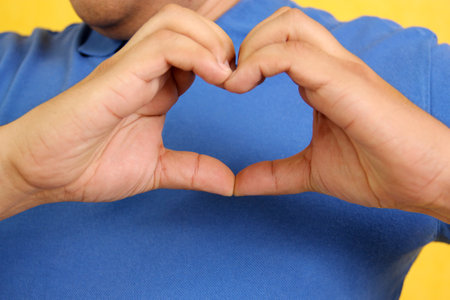 Hands of a Latino man makes sign language, expression and gesture-spatial configuration and visual perception with which deaf people establish a channel of communicationの写真素材