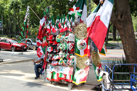 Mexico City, Mexico - September 6, 2023: Street stall selling Mexican tricolor flags, pinwheels, hats and other national itemsのeditorial素材