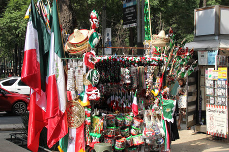 Mexico City, Mexico - September 6, 2023: Street stall selling Mexican tricolor flags, pinwheels, hats and other national itemsのeditorial素材