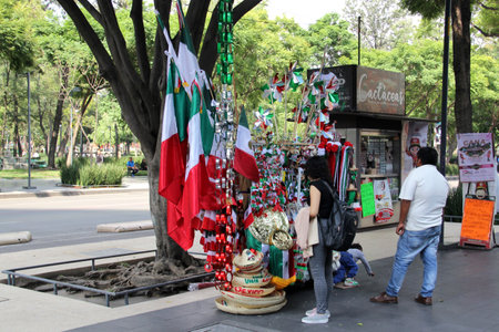 Mexico City, Mexico - September 6, 2023: Street stall selling Mexican tricolor flags, pinwheels, hats and other national itemsのeditorial素材