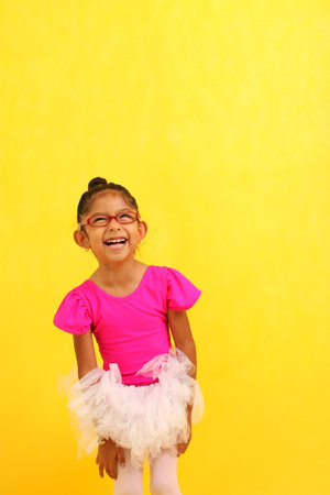 4-year-old Latin brunette girl dressed as a ballerina practices ballet as therapy for autism and ADHDの写真素材