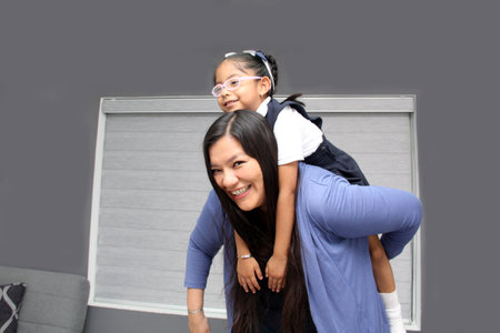 Divorced single mom and 4 year old daughter in uniform, Latina brunette girls play, have fun after...
