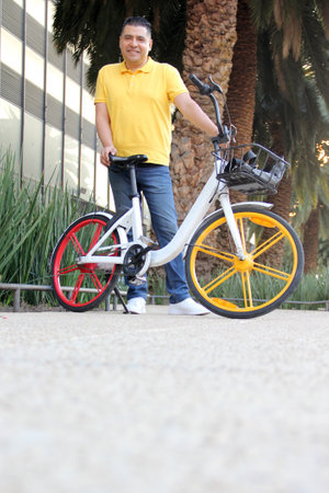 Latino men over 40 years old use public bicycles with free city transportation system tickets to...