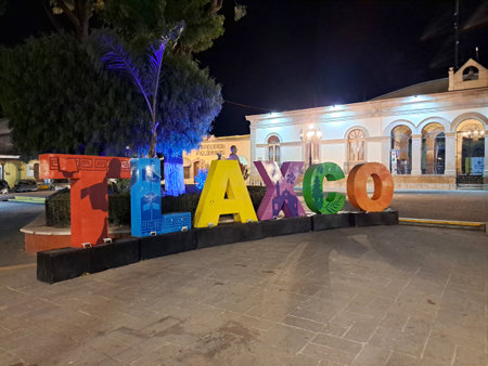 Tlaxco, Tlaxcala, Mexico - Jan 29 2023: Night view of colored letters, the church and government palace in the center of the Mexican city which is a magical townのeditorial素材