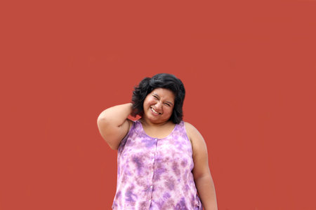 Young 20-year-old woman suffers from back pain due to damage to the bones, joints and muscles of the spinal columnの写真素材