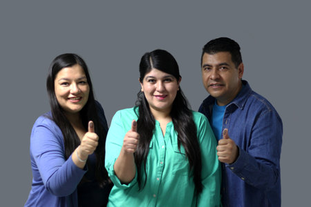 Two Latino women and a man show their thumb inked with indelible electoral ink after voting in the...