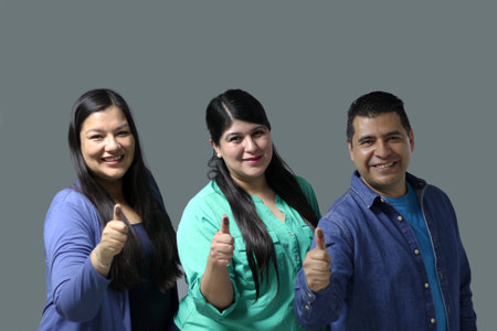 Two Latino women and a man show their thumb inked with indelible electoral ink after voting in the...
