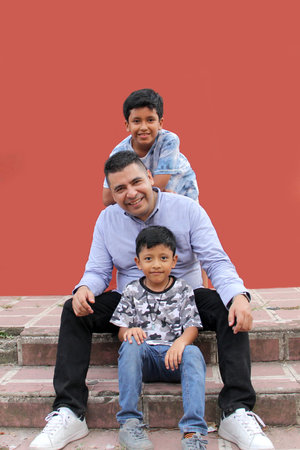 Divorced single dad plays with his two dark-skinned Latino children spends quality time celebrates...
