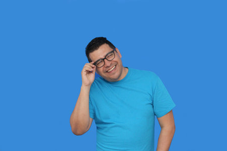 A 40-year-old dark-skinned Latino man uses eyeglasses to see better because he suffers from myopia...