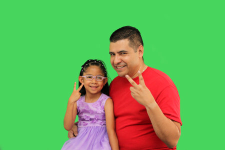 Divorced single dad with his brunette Latin daughter dressed in a princess dress in front of the...