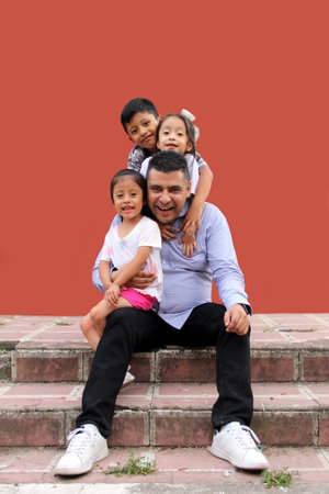 Latin family of a single dad with his 2 daughters and a son are happy and celebrate their day in...