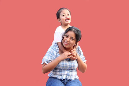 Young Latina mom with her 3 year old daughter with attention deficit disorder ADHD hug and show their love to celebrate mothers dayの写真素材