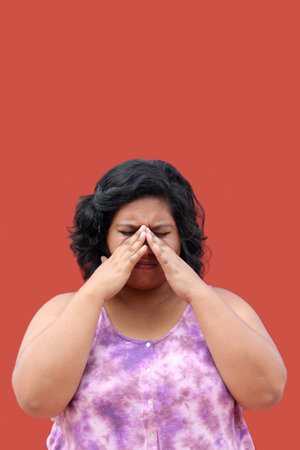 Young 20 year old Latin brunette woman suffers from nasal congestion and pain when she blocks her...