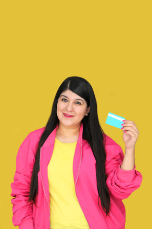 Young adult woman of 30 years old uses her credit card to take advantage of promotions and discounts...