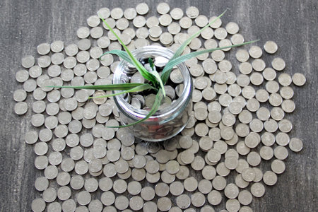 Silver coins for savings and investment fund in crystal glass, abundance and fruit of savings