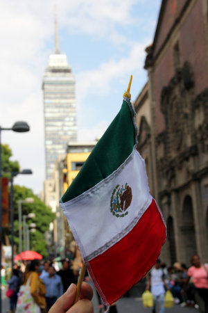 Mexico City, Mexico - Sep 6 2023: Mexican flag in the streets of Mexico with the Torre Latinoamericana to celebrate the national holidays of independence and revolutionのeditorial素材