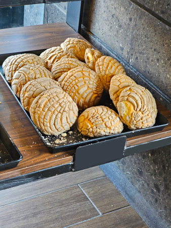 Delicious Mexican Concha sweet bread on bakery trays for sale freshly baked fresh and fluffy