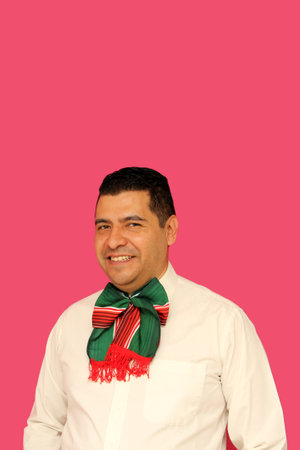 40-year-old dark-skinned Latino man with a tricolor bow with the colors of the Mexican flag to celebrate the national holidays of Mexican Independence Day and Revolution Dayの写真素材