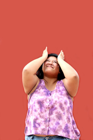 Young 20 year old Latin brunette woman suffers from headache due to stress and migraineの写真素材