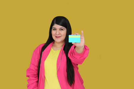 30 year old woman excitedly shows credit card ready to buy with discounts and promotionsの写真素材