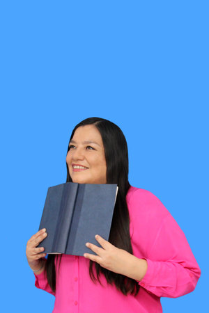 Latina woman reads a book with pleasure and enthusiasm to relax and relieve stress, increase...