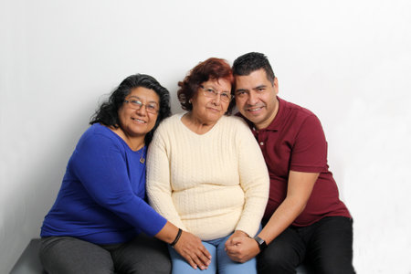 Elderly 80 year old mom with her adult Latina daughter and dark-skinned son spend quality time...