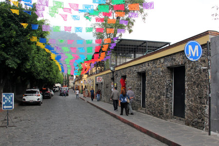 Tepoztlan, Morelos, Mexico - Nov 7 2024: Cobbled streets of the magical town Tepoztlan in Morelos, Mexico, a place of rest, mystical and warm climateのeditorial素材