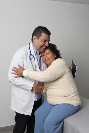 Elderly 80-year-old Latin woman visits the dark-skinned geriatric specialist medical doctor to check...