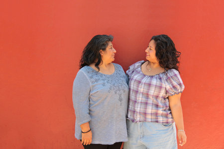 Divorced single mom and 20-year-old Latina daughter are happy to spend time together celebrating Mother's Dayの写真素材