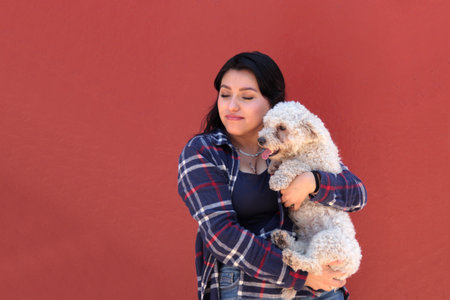 A 25-year-old brunette Latina woman shows off the stray dog â€‹â€‹she adopted, now her...