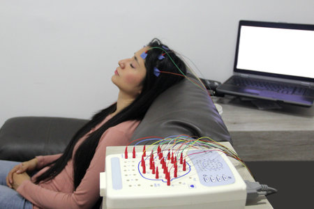 Electroencephalogram on a 20-year-old latin woman to measure brain electrical activity and diagnose...