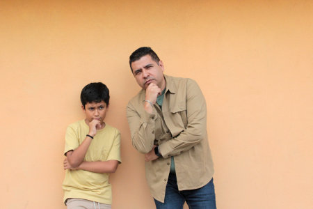 Single dad plays with his 10-year-old dark-skinned Latino son, spending time together to celebrate...