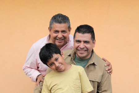 Three generations of a dark-skinned Latino grandfather, father, and son show their love and spend time together to celebrate Father's Dayの写真素材