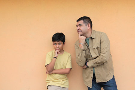 Single dad plays with his 10-year-old dark-skinned Latino son, spending time together to celebrate Father's Dayの写真素材