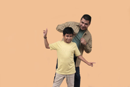 Single dad plays with his 10-year-old dark-skinned Latino son, spending time together to celebrate Father's Dayの写真素材